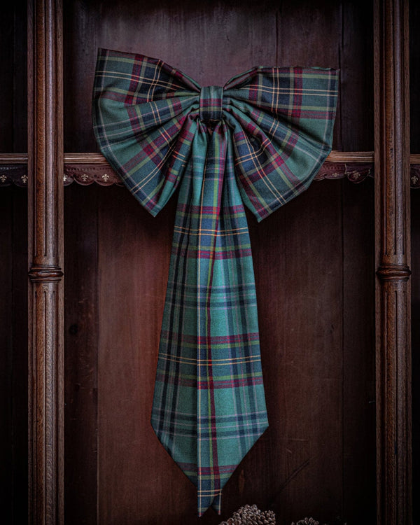 Tartan door bow on a wooden background