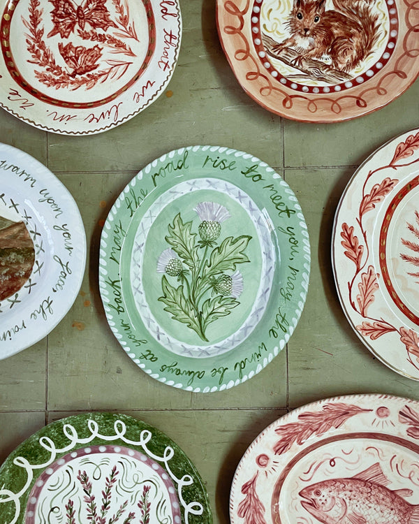 Collection of decorative plates with various patterns on a wooden surface