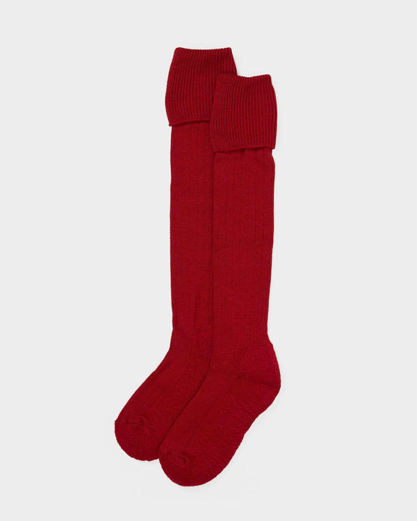 Red knee-high socks on a light gray background