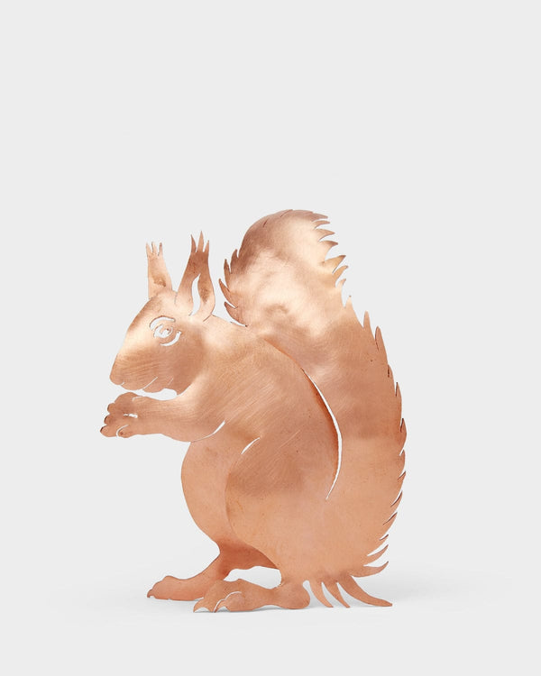 Decorative squirrel figurine on a white background